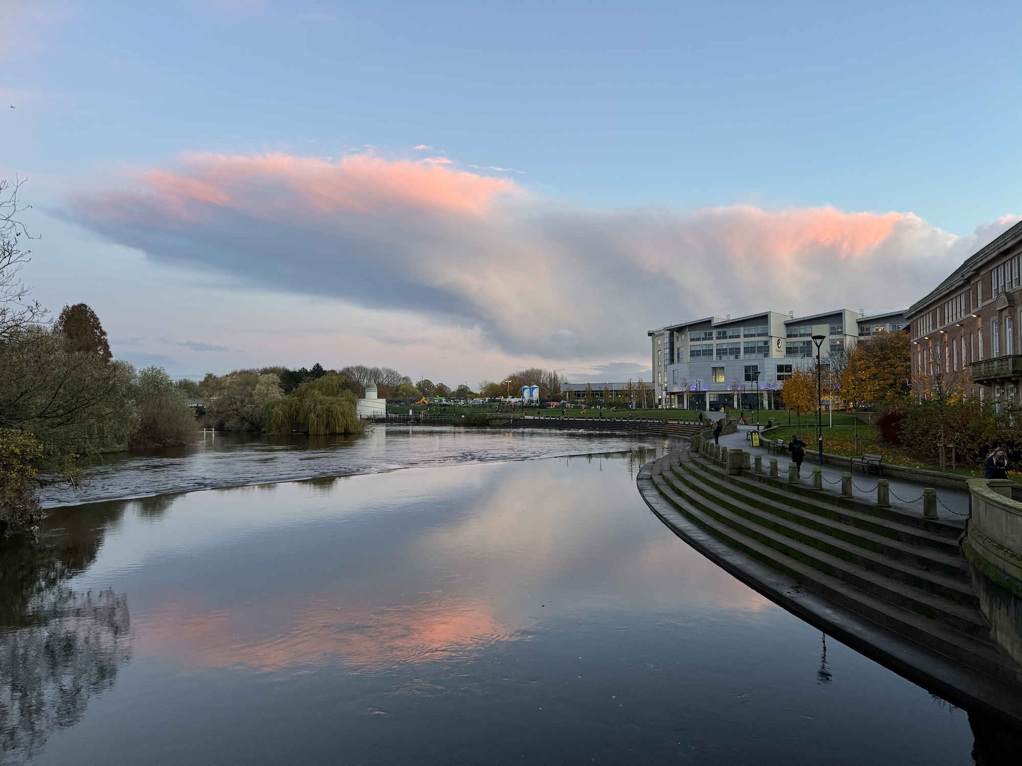 a view of the River Derwent at Derby taken from Exeter Bridge with the River Gardens and the Council House to the right. Most striking is the pink anvil-shaped cloud.